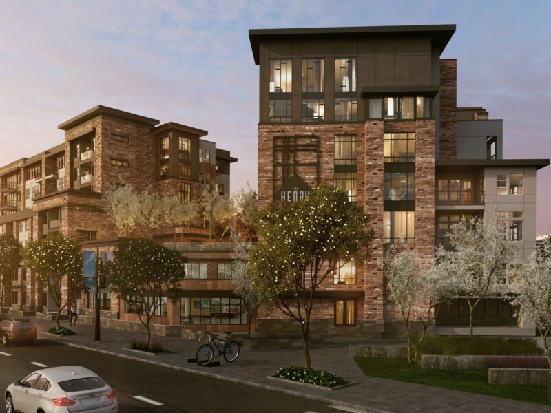 Exterior of 7-story apartment complex with sidewalk and roadway in foreground