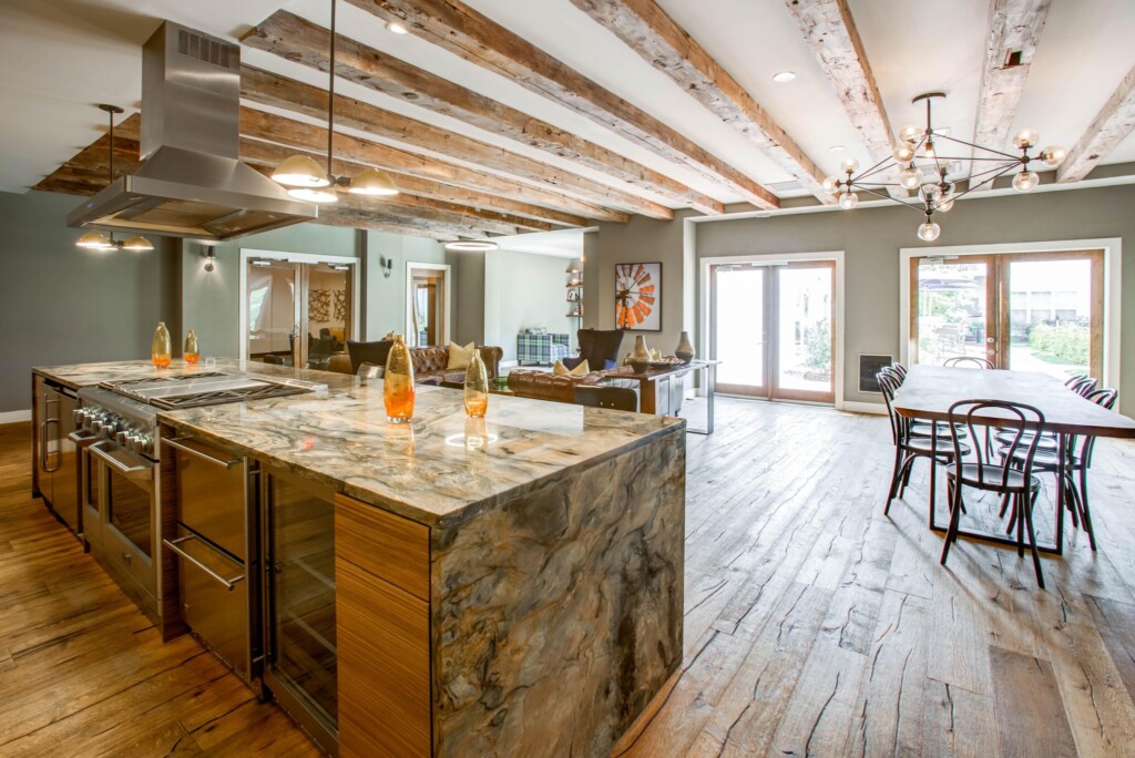 Interior of large open room with kitchen, dining table, and living room area.