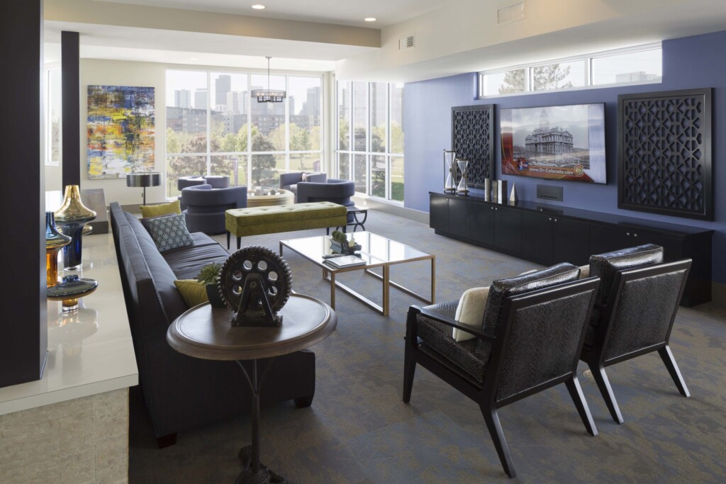 Interior of common area with couch, modern chairs and large-screen television.