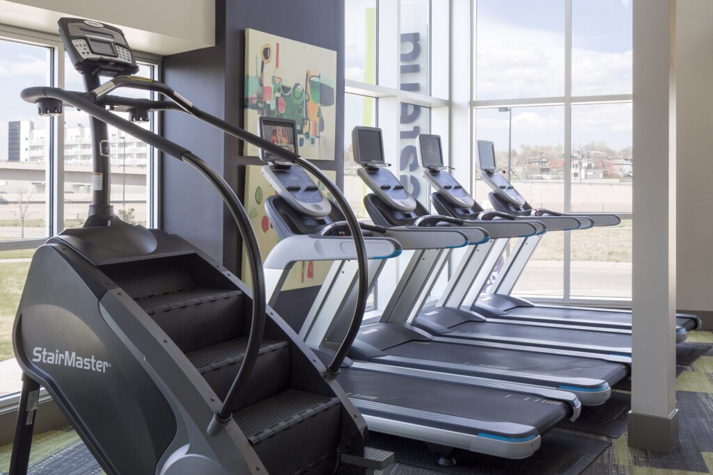 Interior of fitness center with treadmills and stair climbing machines.