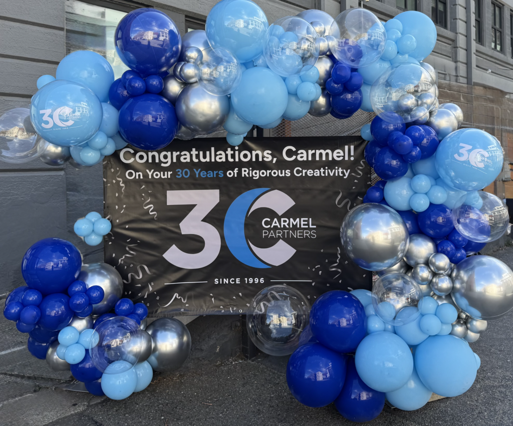 Balloons surround text celebrating Carmel's 30th anniversary